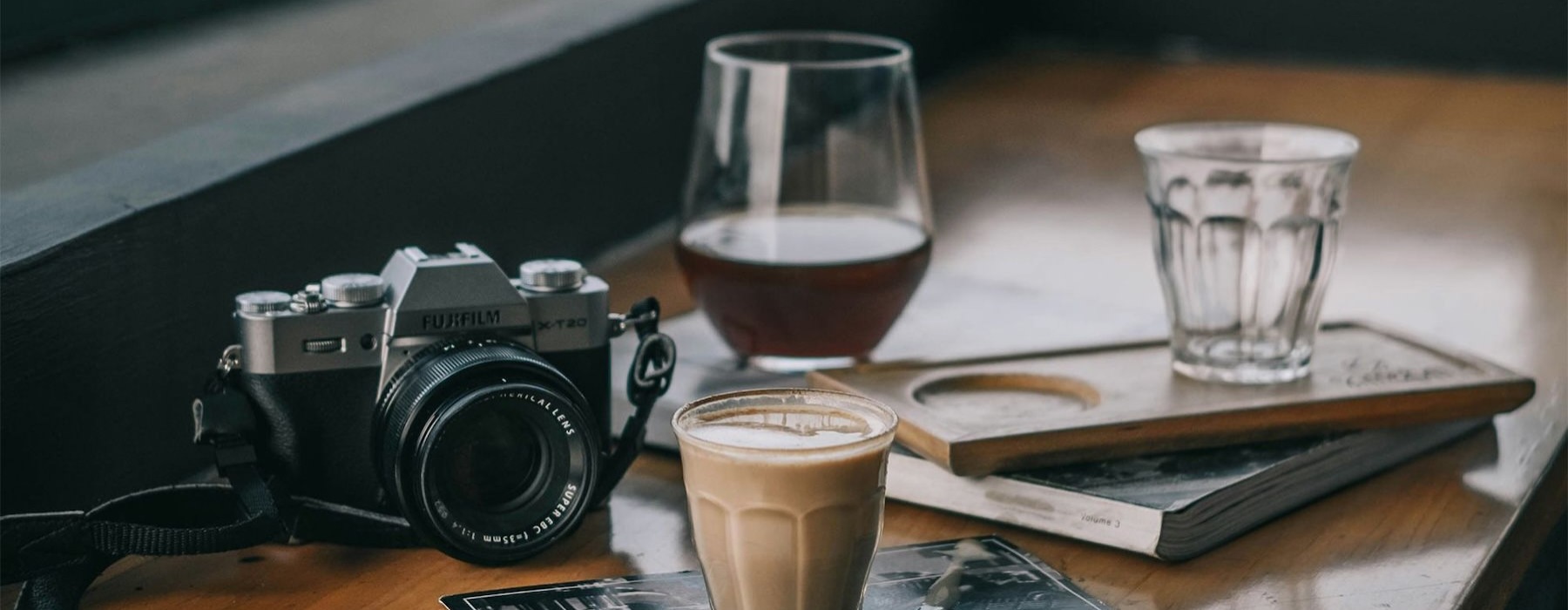 a camera and cup of coffee on a table