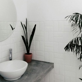 a bathroom with a round mirror