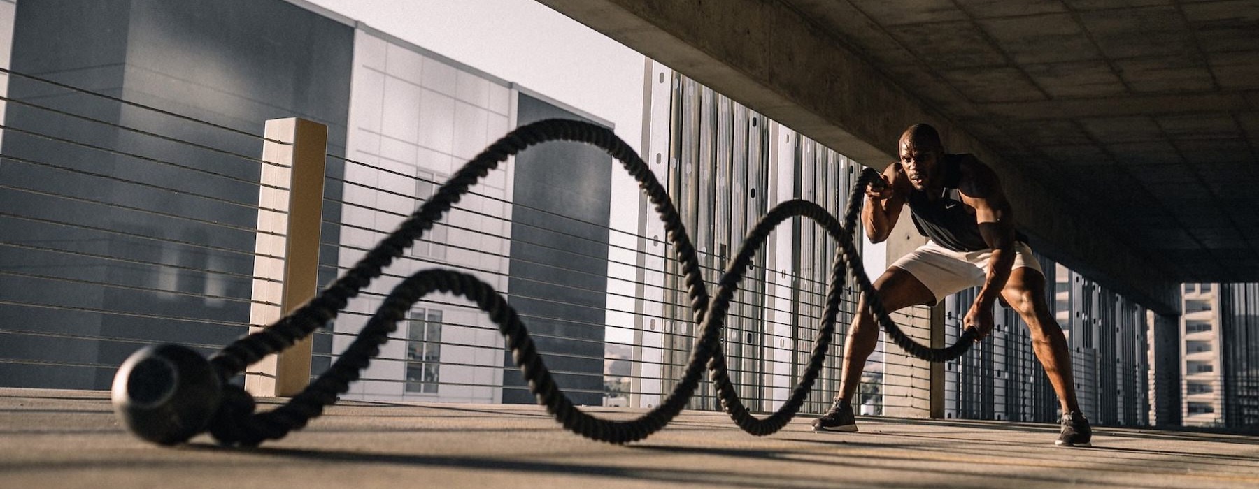 a person working out with ropes in a garage