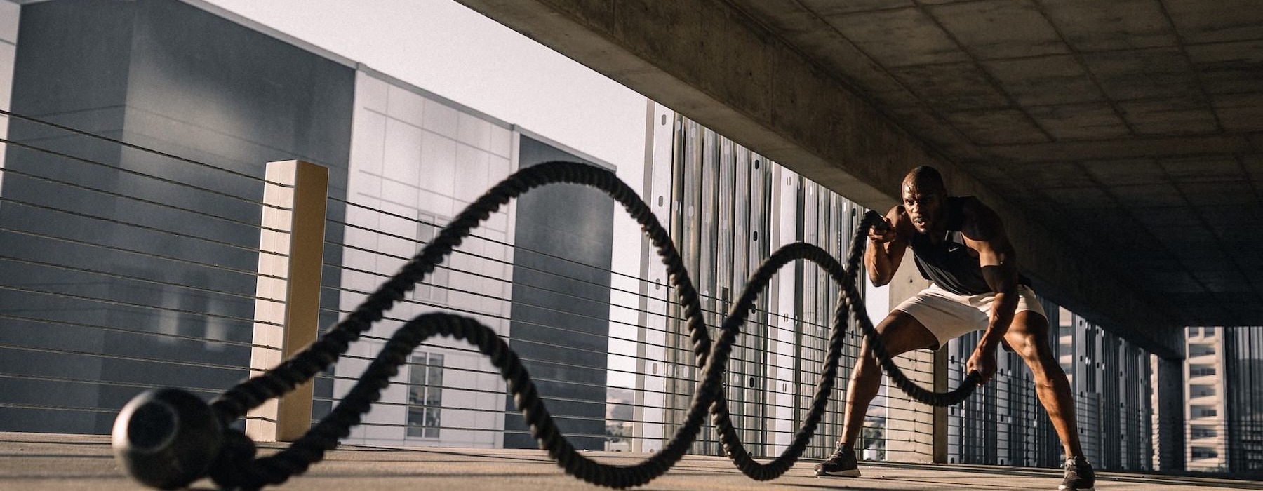 a person working out with ropes in a garage